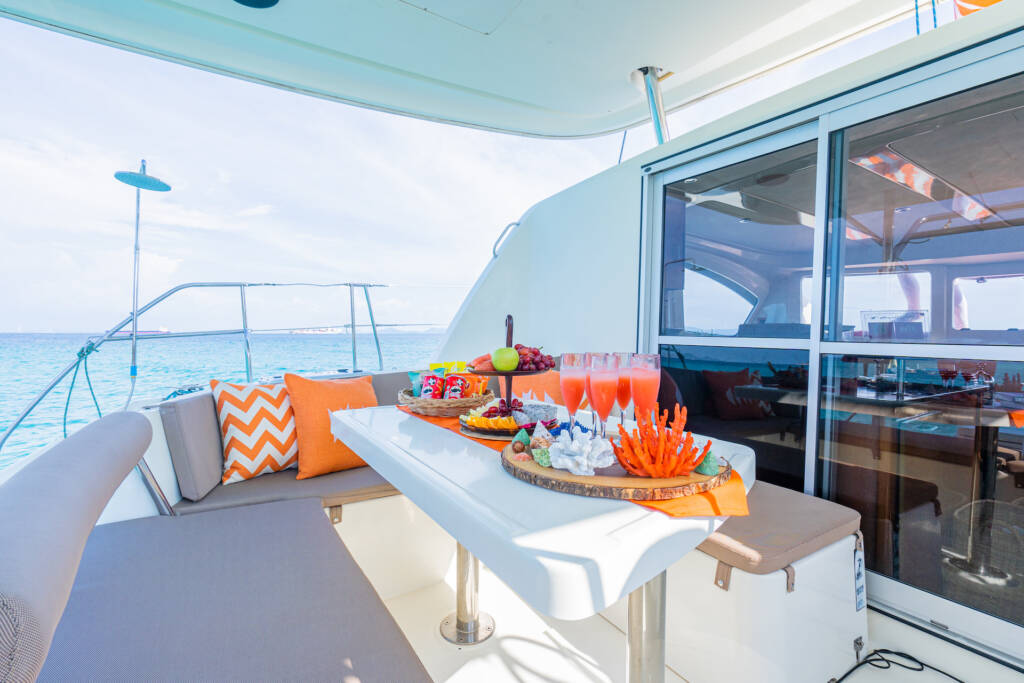 Shaded outdoor seating beside the saloon on Rose catamaran